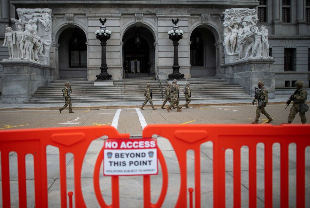 PHOTO: Members of the National Guard patrol outside the Pennsylvania Capitol Building on Jan. 17, 2021, in Harrisburg, Pa.