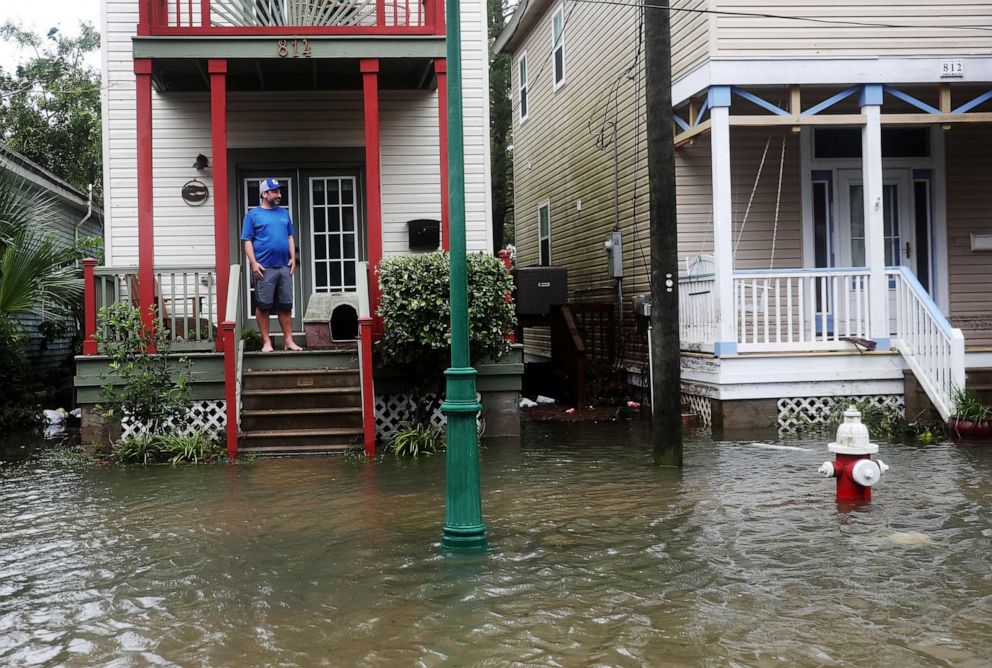 PHOTO: In this Sept. 16, 2020, file photo, John Terrezza looks out at a flooded street in front of his home as Hurricane Sally passes through the area, in Pensacola, Fla.