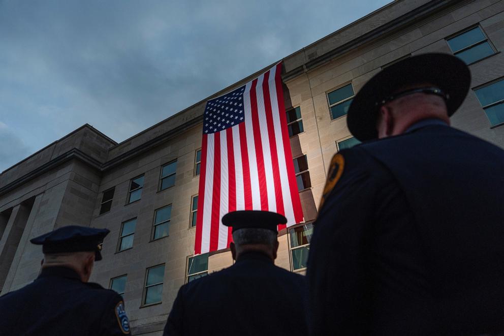 PHOTO: First responders watch as an American flag is unfurled from the top of the Pentagon at sunrise, Thursday, Sept. 11, 2025, in Washington.