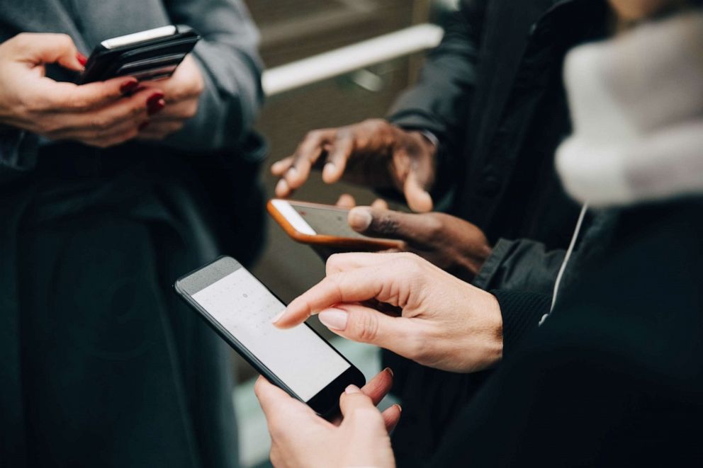 PHOTO: Stock photo of people using cellphones.