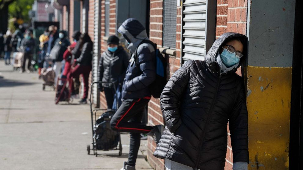 PHOTO: Recipients of the nonprofit organization The River Fund wait in line to receive free groceries on May 9, 2020, in Queens, New York.