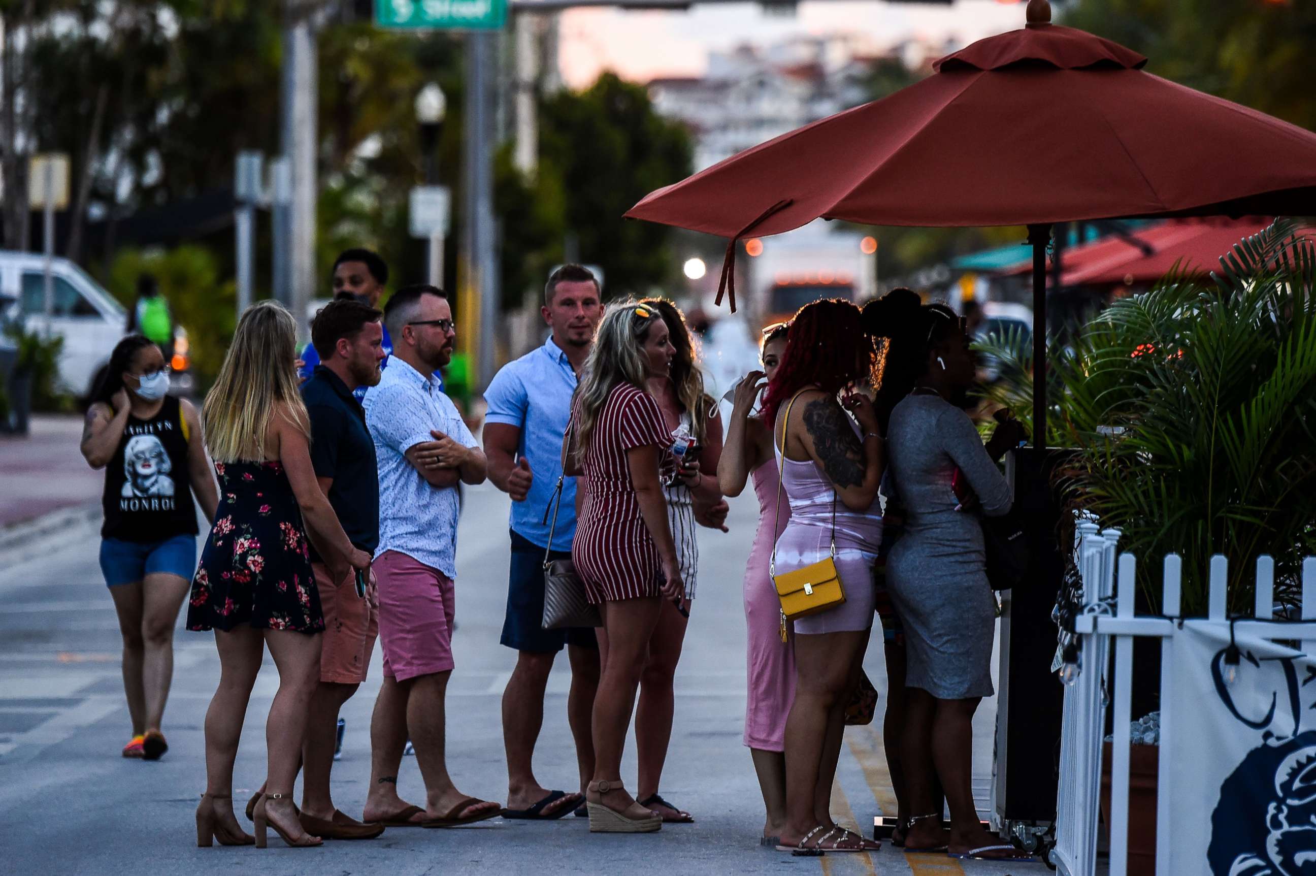 PHOTO: People stand in line to enter a restaurant on Ocean Drive in Miami Beach, Fla., June 26, 2020.
