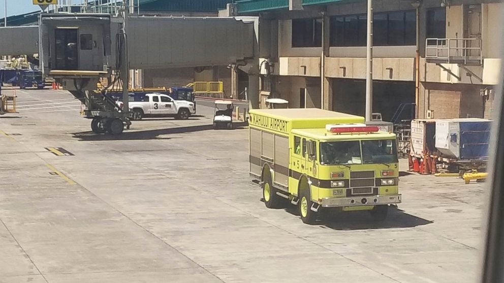 This Friday, Aug. 31, 2018 photo provided by Nicholas Andrade shows a fire truck outside a Hawaiian Airlines jet in Kahului, Hawaii, after a can of pepper spray went off inside the plane during a flight from Oakland, Calif. 