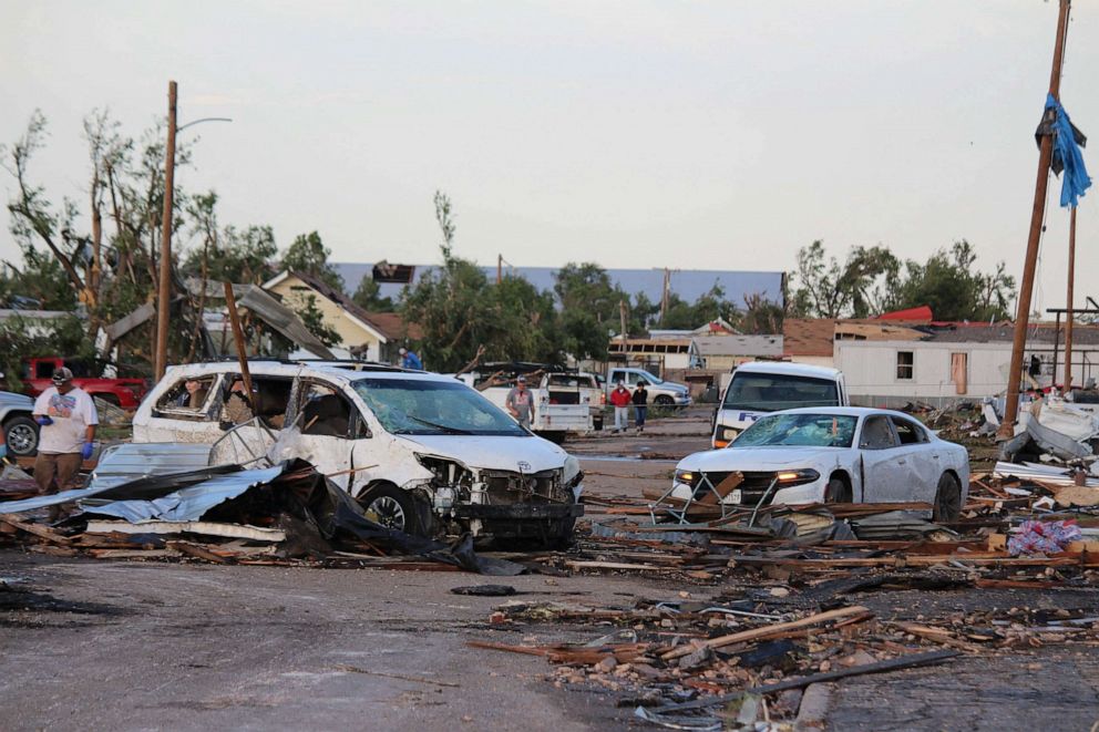 PHOTO: Debris and damaged vehicles cover a street after a tornado hit Perryton, Texas, June 15, 2023.