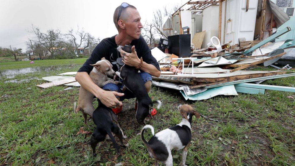 PHOTO: Sam Speights tries to hold back tears while holding his dogs and surveying the damage to his home in the wake of Hurricane Harvey, Aug. 27, 2017, in Rockport, Texas.