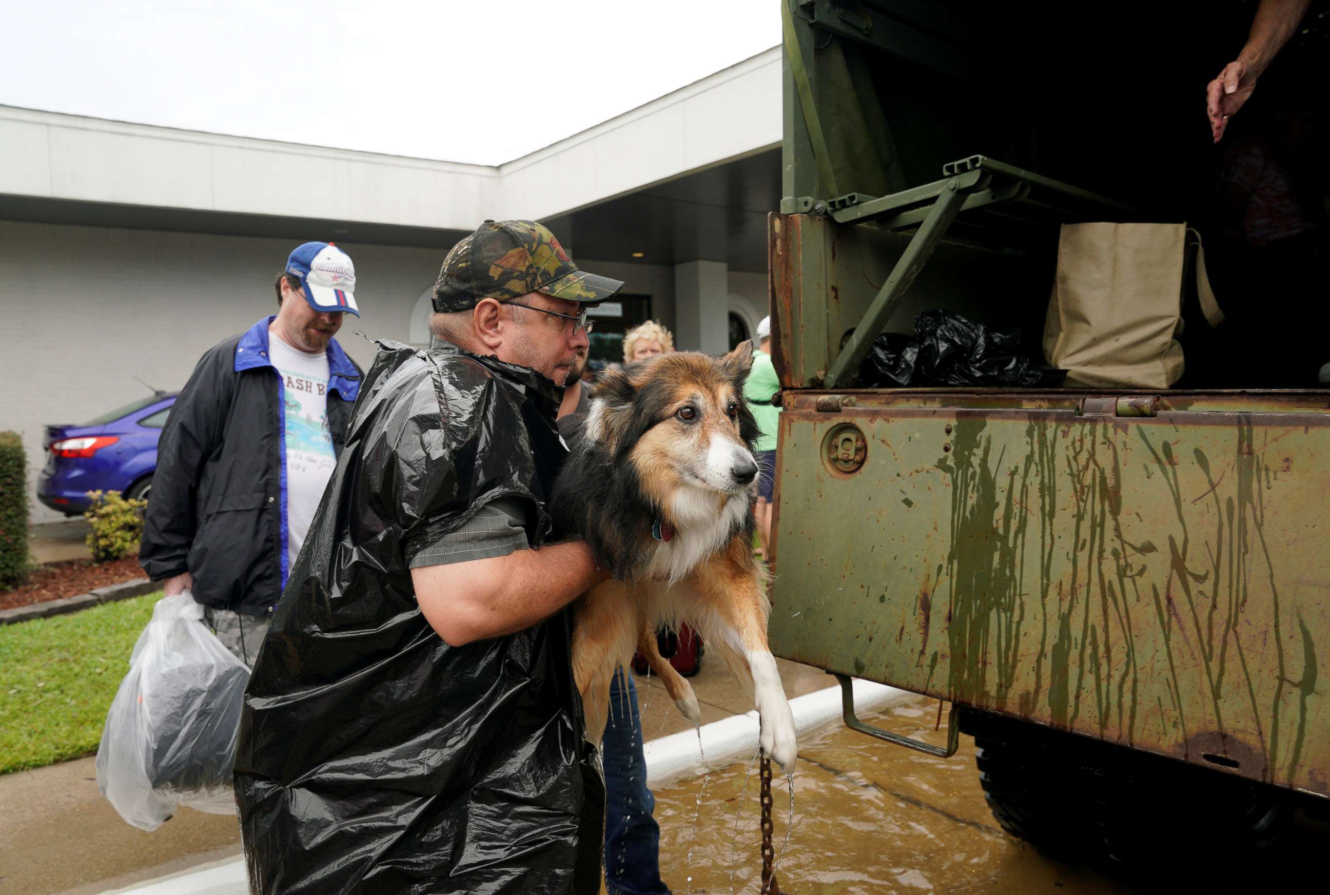 PHOTO: Volunteers load pets into a collector's vintage military truck to evacuate them from flood waters from Hurricane Harvey in Dickinson, Texas, Aug. 27, 2017. 