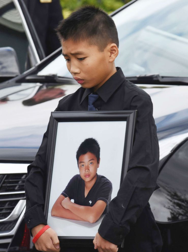 PHOTO: Alex Wang holds a picture of his brother, Peter Wang, a victim in the shooting at Marjory Stoneman Douglas High School, after his brother's funeral on Feb. 20, 2018, at Kraeer Funeral Home in Coral Springs, Fla.