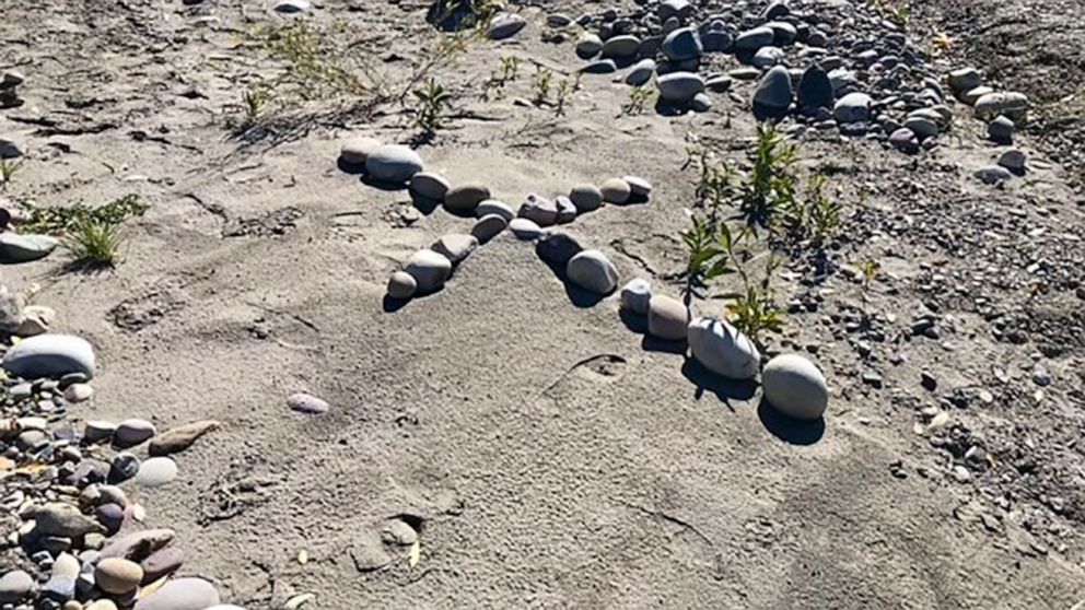 PHOTO: A cross made out of river stones was is seen on Sept. 21, 2021, near an area of the Spread Creek Dispersed Campground in the Bridger-Teton National Forest where a body matching the description of Gabby Petito was discovered.