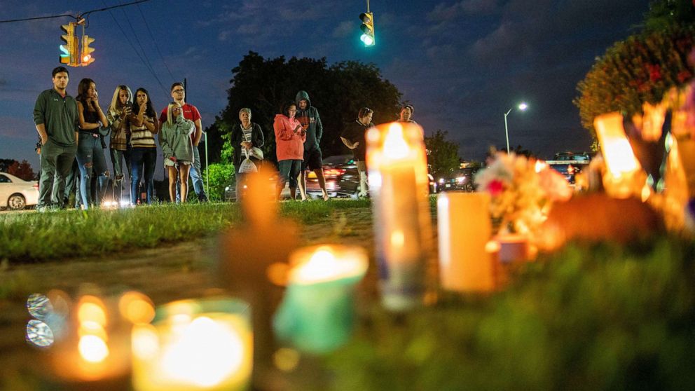 PHOTO: People pay respect in a makeshift memorial during a candlelight vigil for travel blogger Gabby Petito in Blue Point, New York, Sept. 24, 2021.