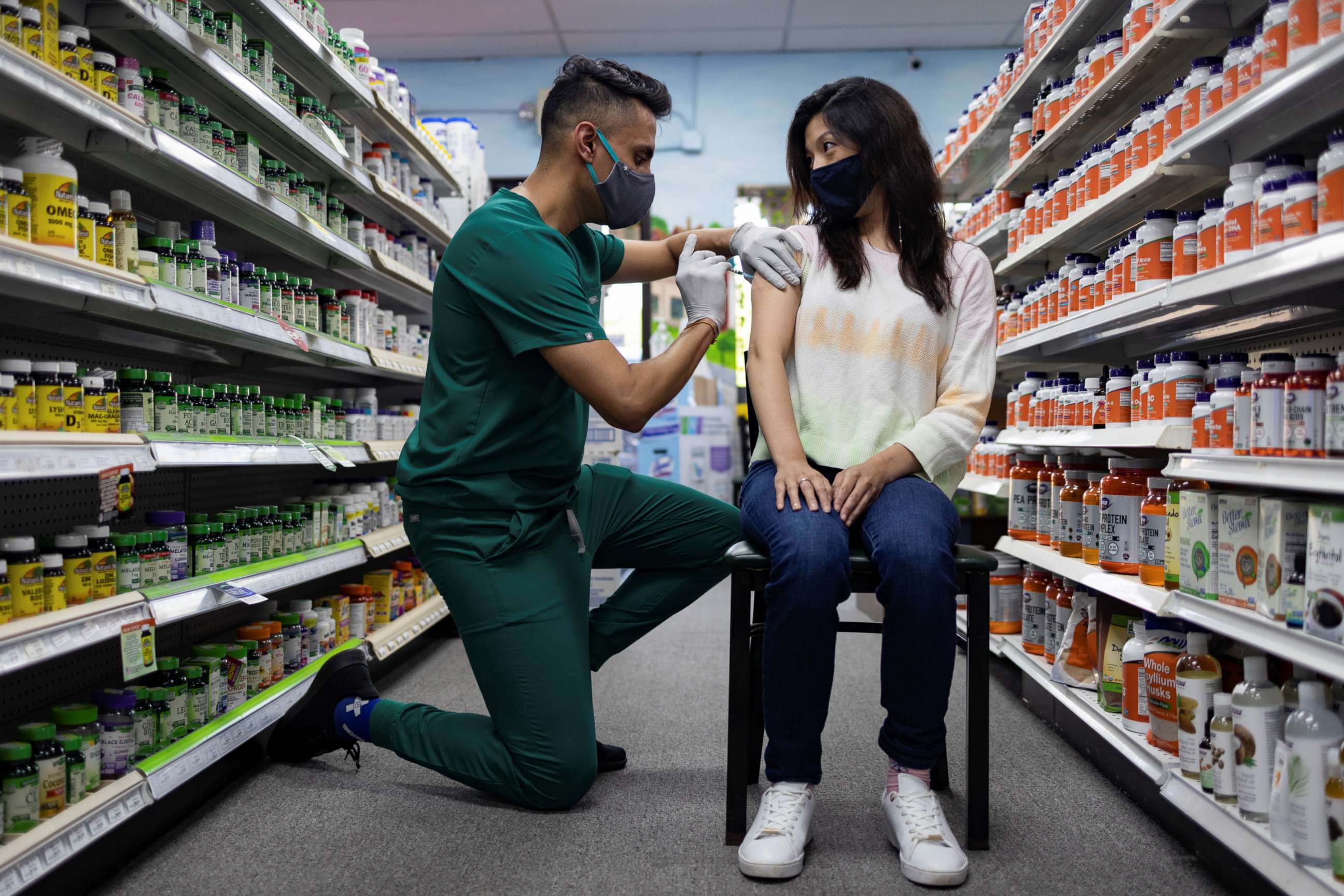 PHOTO: A woman receives the Pfizer-BioNTech coronavirus disease vaccine as a booster dose at Skippack Pharmacy in Schwenksville, Pa., Aug. 14, 2021.