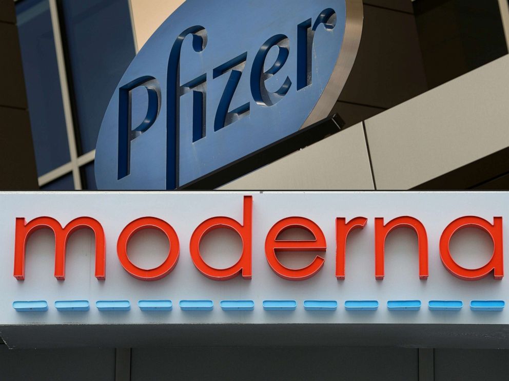 PHOTO: This combination of file pictures created on August 05, 2020 shows a sign for Pfizer pharmaceutical company on a building in Cambridge, Mass., on March 18, 2017, and the Moderna headquarters in Cambridge, Mass., on May 18, 2020.