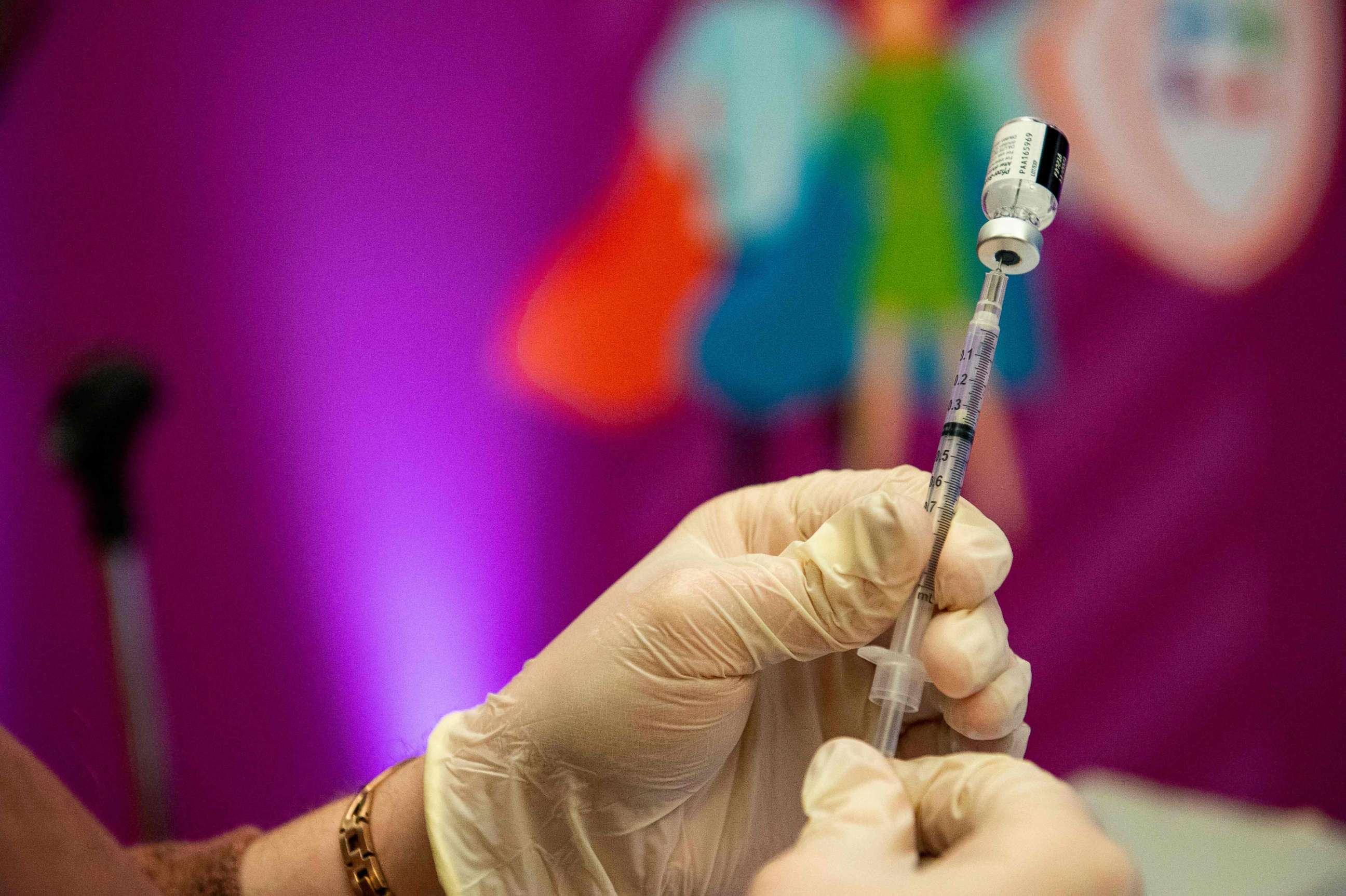 PHOTO: (FILES) In this file photo taken on January 06, 2022 a medical worker prepares the Pfizer-BioNTech Covid-19 vaccine booster to be given to children 12-15 years old at Hartford Hospital in Hartford, Connecticut. 