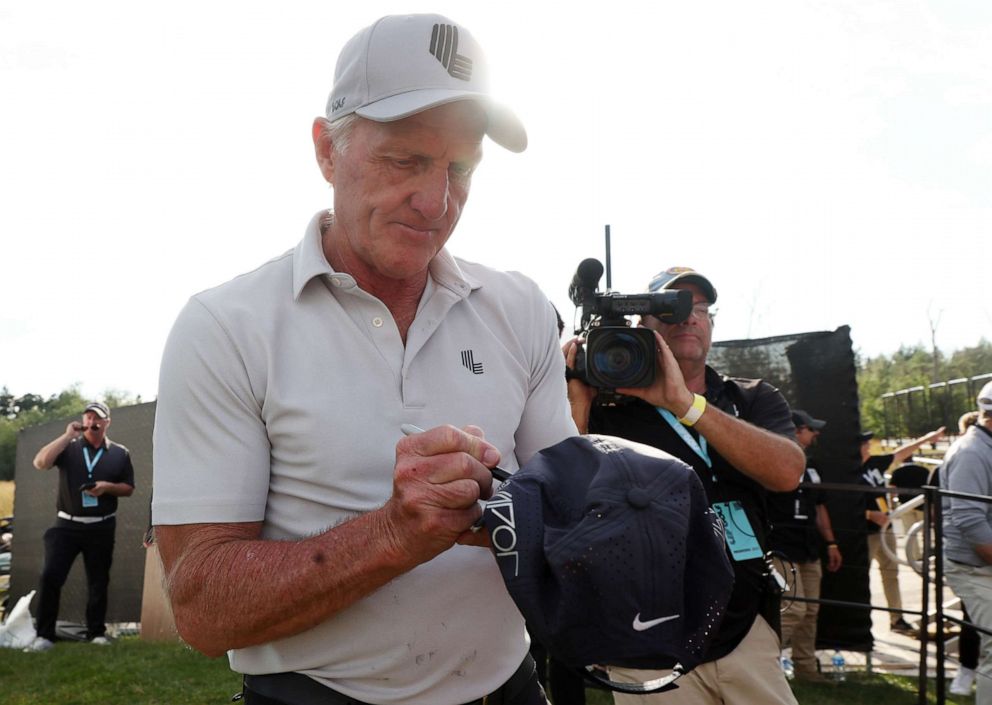 PHOTO: Greg Norman, CEO and commissioner of LIV Golf, autographs a hat during day three of the LIV Golf Invitational - Portland at Pumpkin Ridge Golf Club in in North Plains, Ore., July 02, 2022.