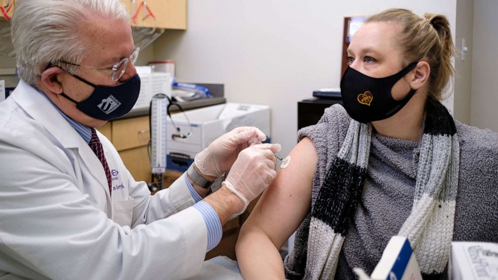 PHOTO: Pharmacist John Forbes gives the Moderna GOVID-19 vaccine to Meghan Bohlander, a physician's assistant, at the Medicap Pharmacy in Urbandale, Iowa, Jan. 5, 2021.