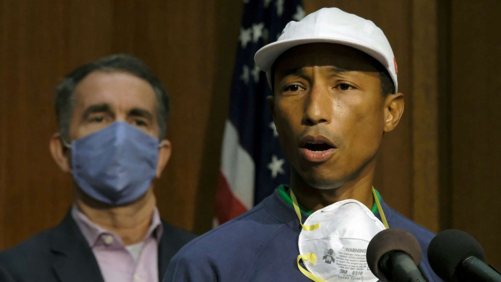 PHOTO: Performing artist and Virginia native Pharrell Williams, right, speaks about the plan to make Juneteenth a state holiday as Virginia Gov. Ralph Northam, left, listens during a press briefing in Richmond, Va., Tuesday, June 16, 2020.