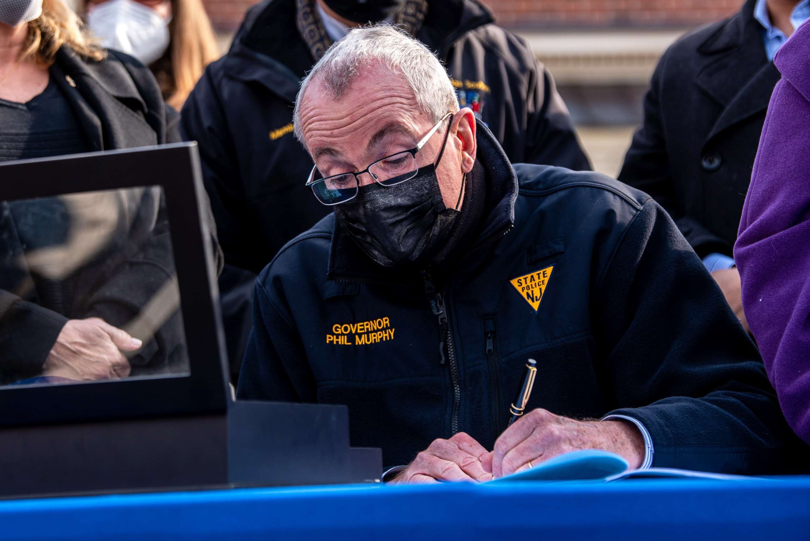 PHOTO: Gov. Phil Murphy signs an abortion bill into law in front of Teaneck Library on Jan. 13, 2022, in Teaneck, N.J.
