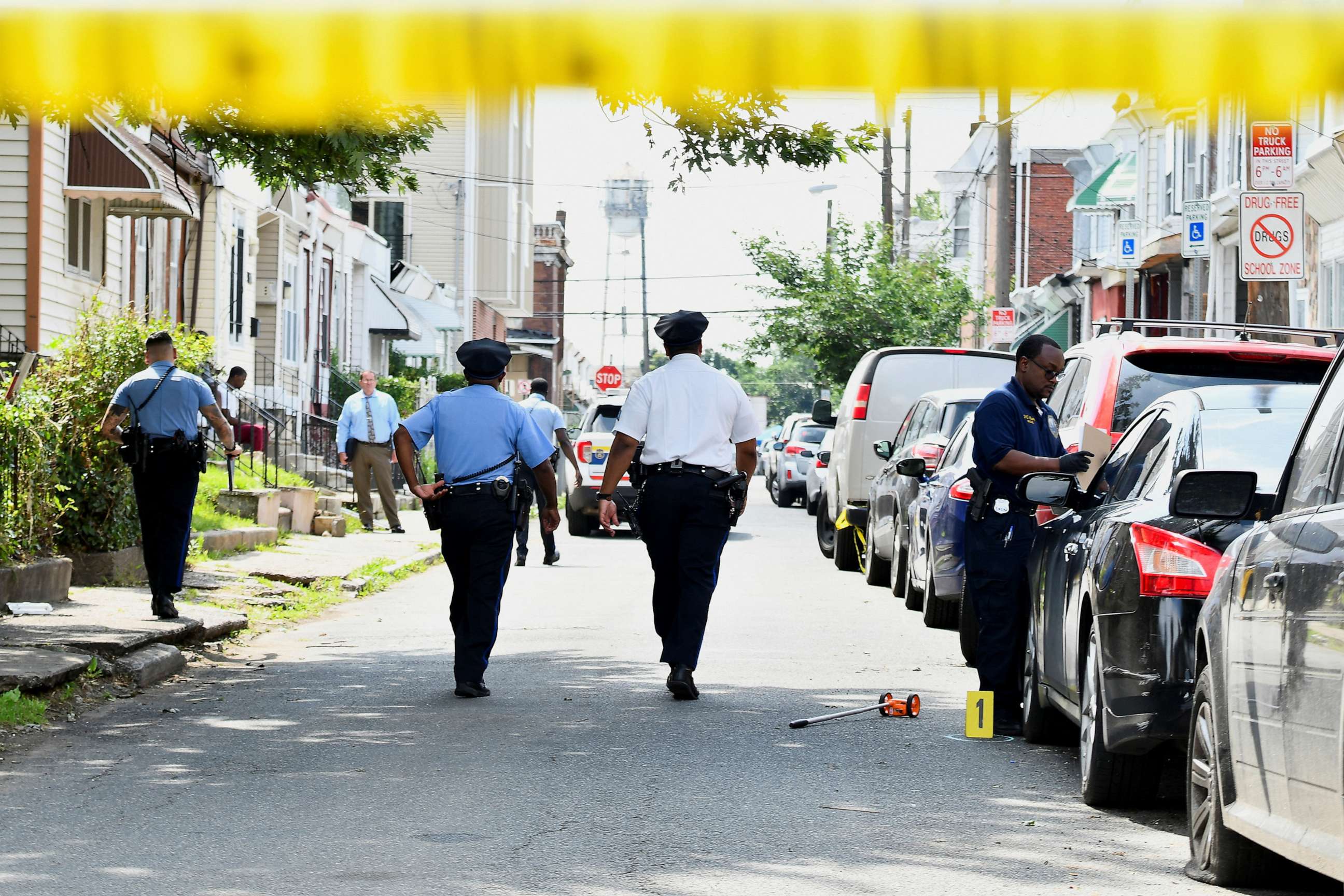PHOTO: Police officers work at the scene as investigations are ongoing the day after a mass shooting in the Kingsessing section of southwest Philadelphia, July 4, 2023.