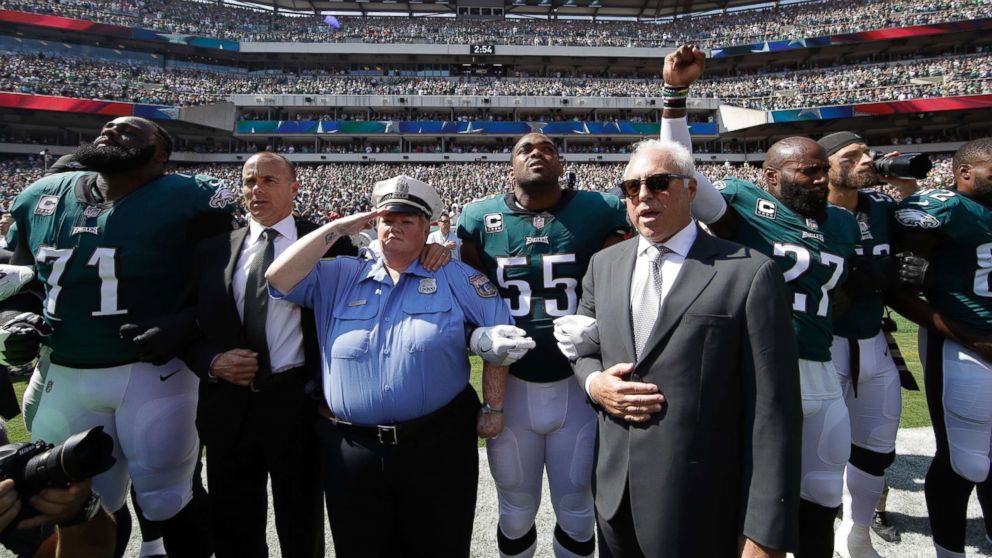 PHOTO: Philadelphia Eagles players and owners Jeffrey Lurie stand for the national anthem before an NFL football game against the New York Giants, Sept. 24, 2017, in Philadelphia.