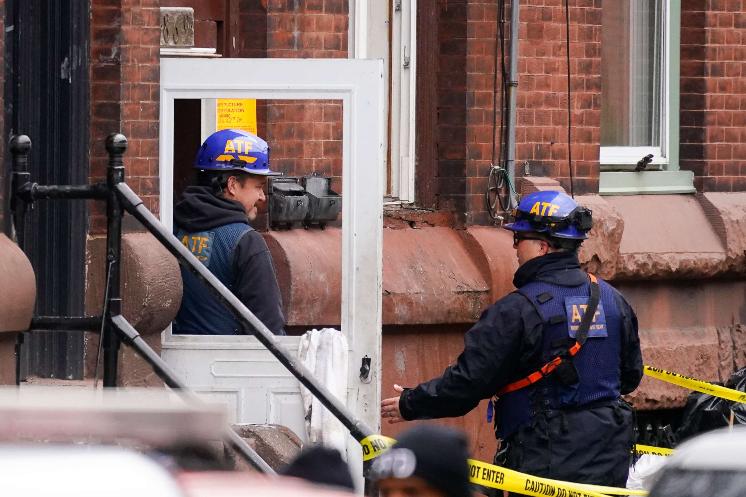 PHOTO: Investigators gather near the entrance to the building of Wednesday's fatal fire in the Fairmount neighborhood of Philadelphia, Thursday, Jan. 6, 2022.