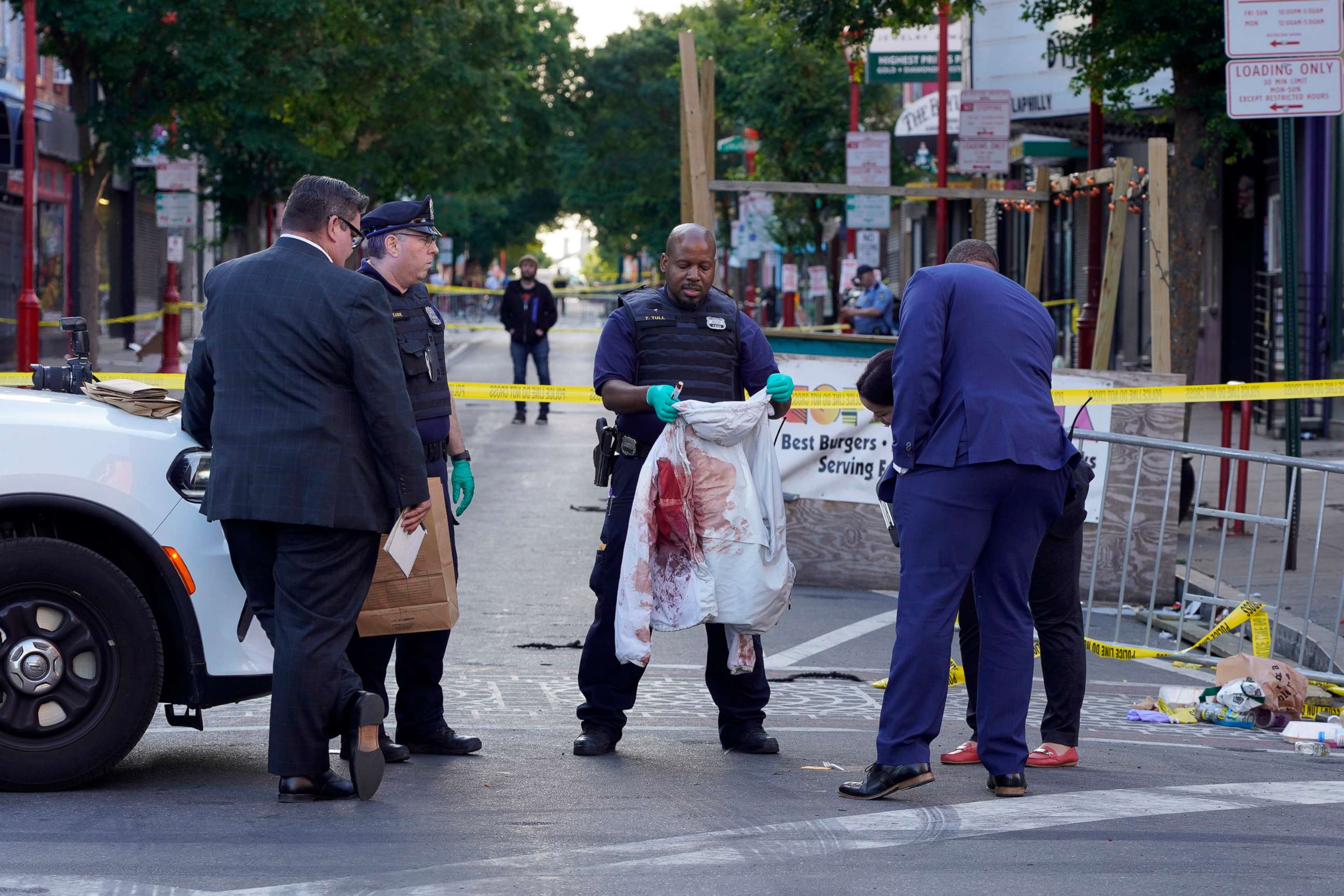 PHOTO: Philadelphia Police investigators work the scene of a fatal overnight shooting on South Street in Philadelphia, June 5, 2022. 