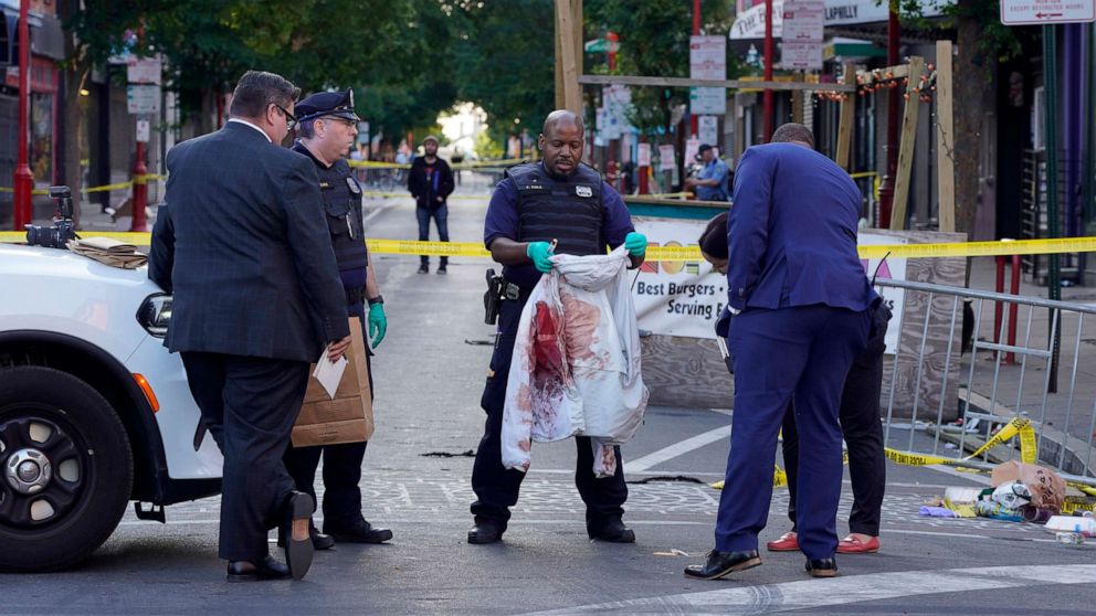 PHOTO: Philadelphia Police investigators work the scene of a fatal overnight shooting on South Street in Philadelphia, June 5, 2022. 