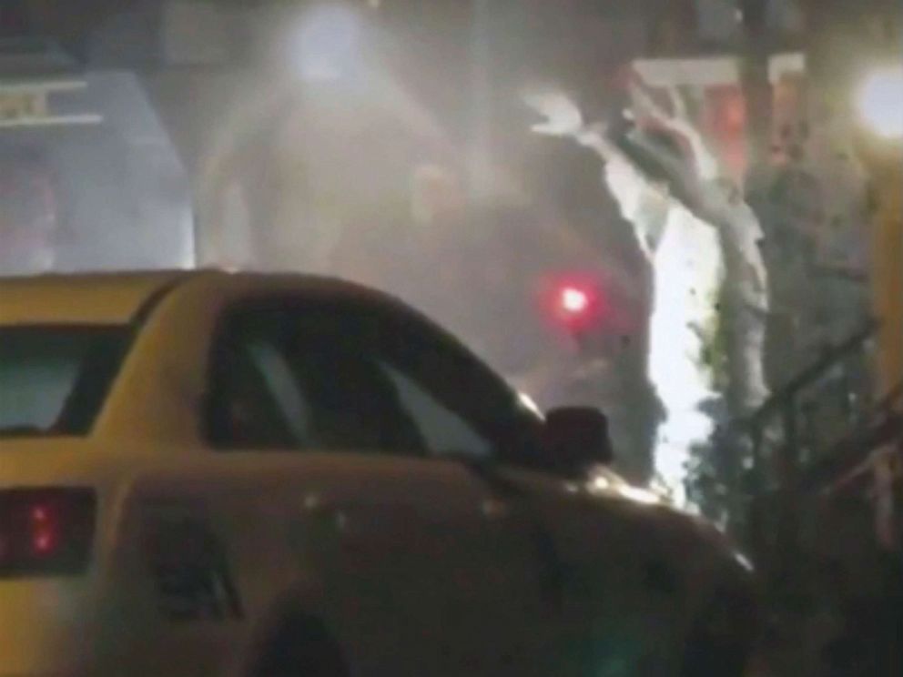 PHOTO: A man exits a building with hands up in Philadelphia, Aug 14, 2019.