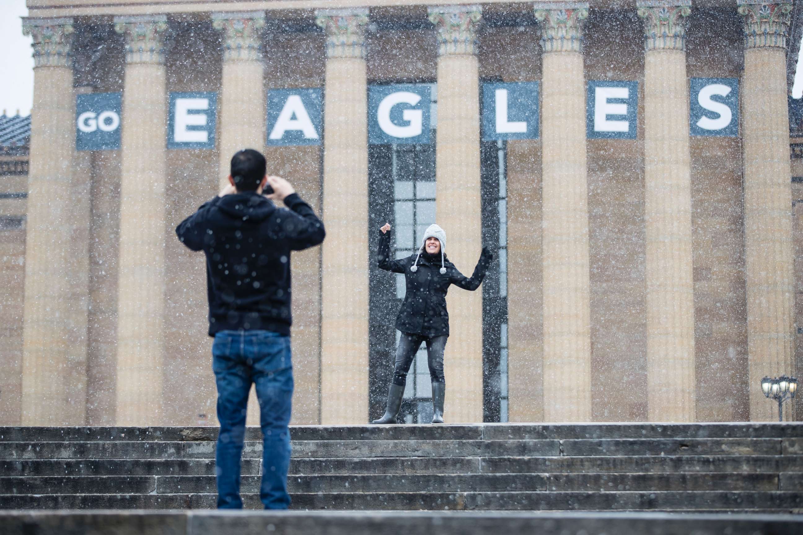 PHOTO: A woman poses for a photograph in view of a Philadelphia Eagles banner hung on the Philadelphia Museum of Art in Philadelphia, Penn., Jan. 30, 2018. 