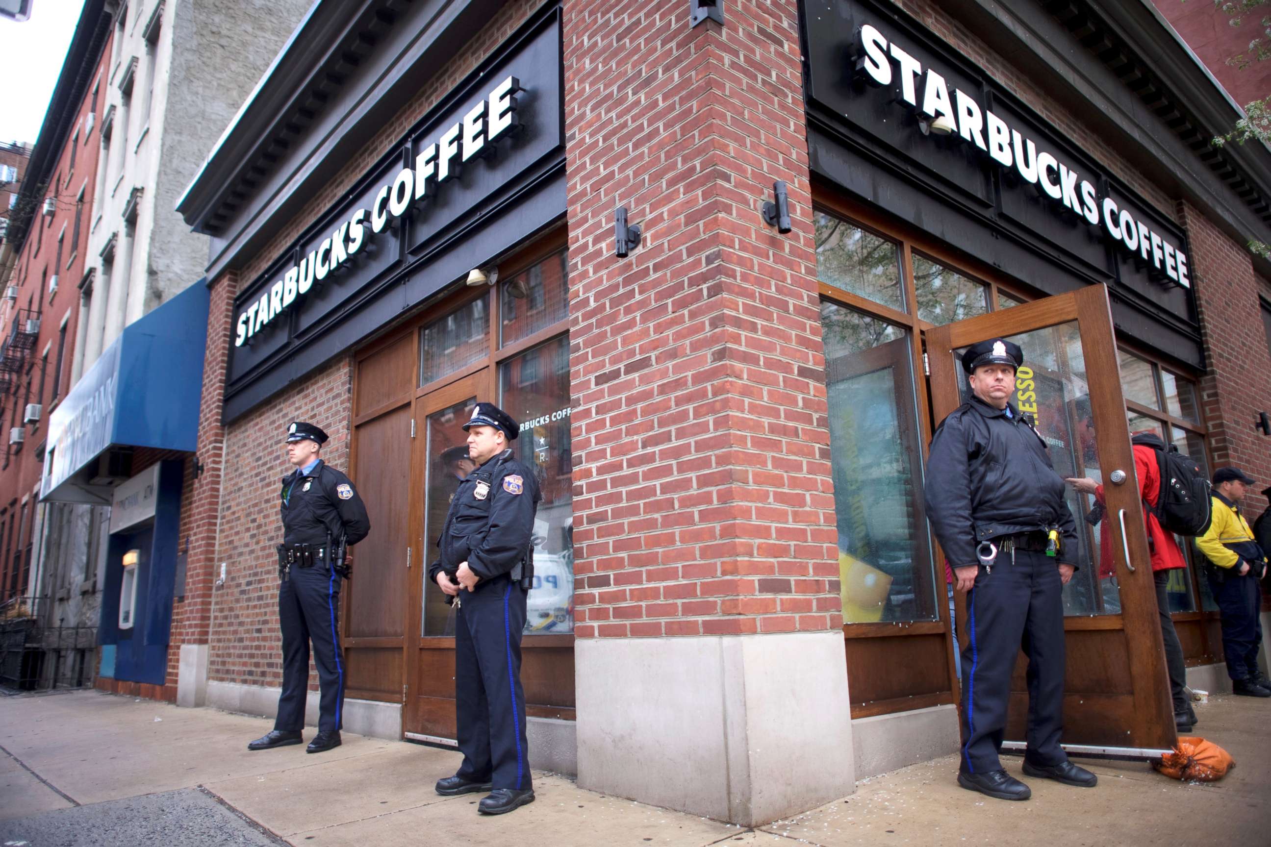PHOTO: Police officers monitor activity outside as protestors demonstrate inside a Center City Starbucks, where two black men were arrested, in Philadelphia, April 16, 2018.