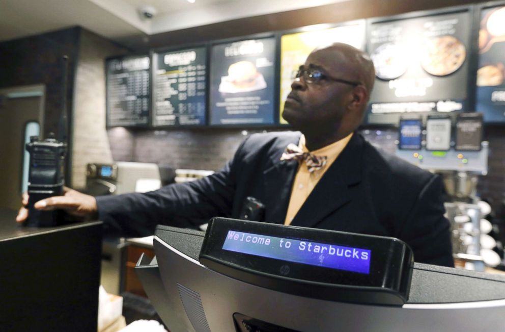 PHOTO: A plain-clothed police officer mans a position behind the counter at the Starbucks that has become the center of protests, April 16, 2018, in Philadelphia.