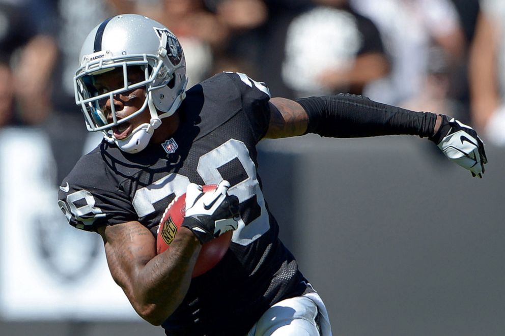 PHOTO: Oakland Raiders cornerback Phillip Adams carries the ball on a 30-yard punt return against the Jacksonville Jaguars in Oakland, Calif., Sept. 15, 2013.