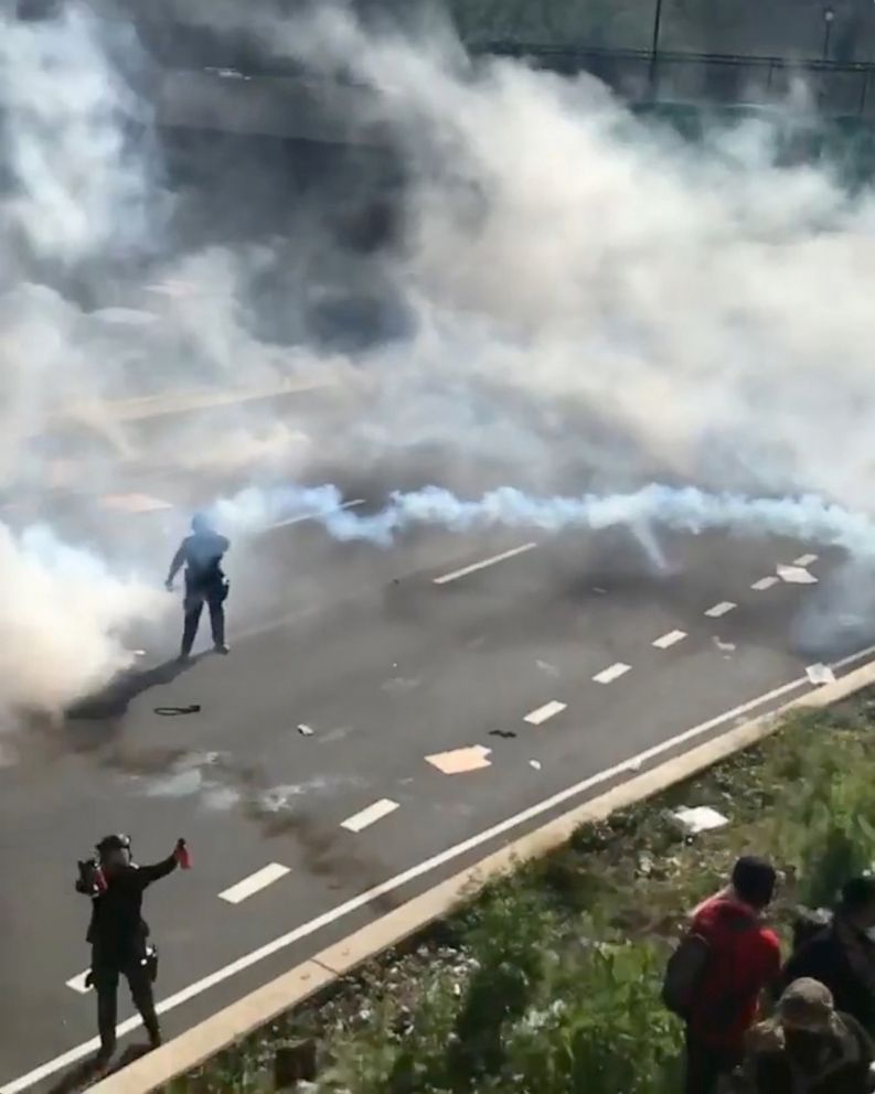 PHOTO: Protesters attempt to climb a hill next to a highway as tear gas is fired by police during a protest against the death of George Floyd, in Philadelphia, June 1, 2020.