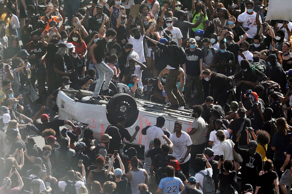 PHOTO: Protesters jump on a car they overturned near the Municipal Services Building in Philadelphia during a Justice for George Floyd rally Saturday, May 30, 2020. Floyd died in Minneapolis police custody on May 25.