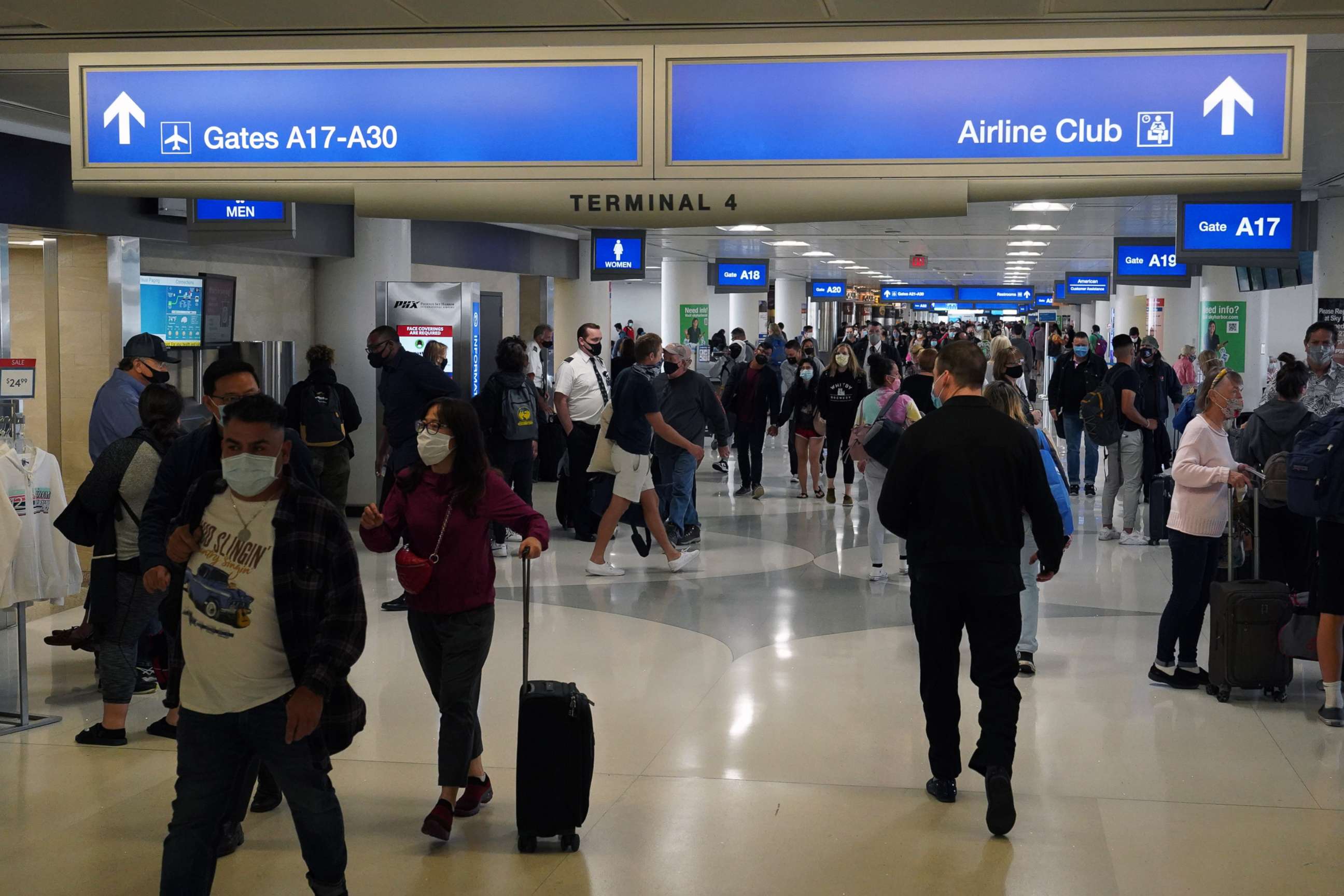 PHOTO: People walk through Terminal 4 of the Sky Harbor International Airport, April 1, 2021, in Phoenix.