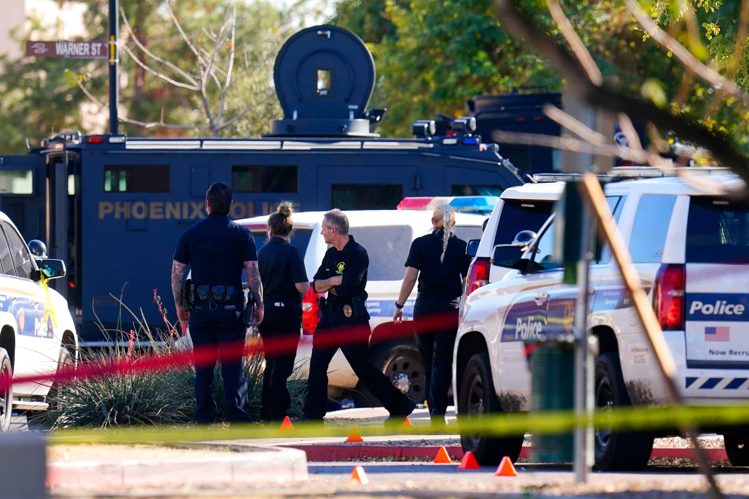 PHOTO: A large police presence is seen near a house where several police officers were shot after responding to a shooting inside the home Friday, Feb. 11, 2022, in Phoenix.