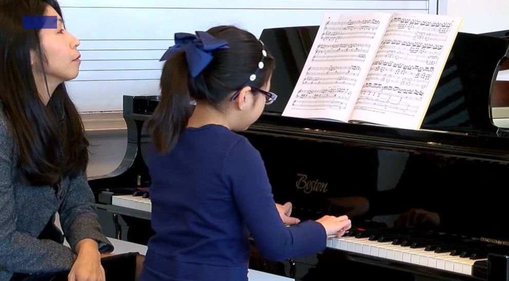PHOTO: Sophia Suwiryo, 9, with her piano teacher Takako Frautschi, Feb. 1, 2018, in Cincinnati.