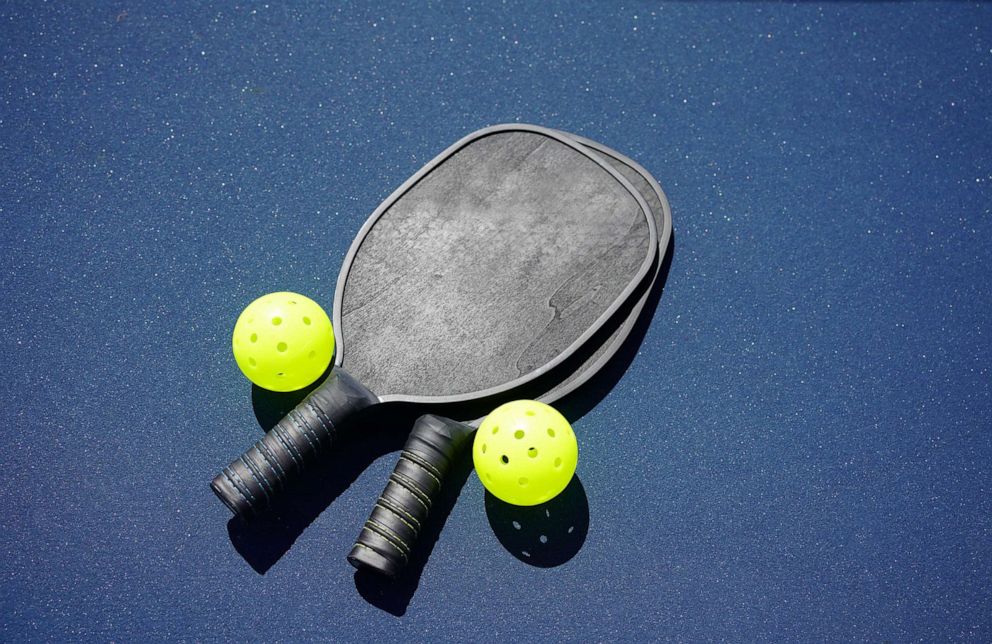 PHOTO: FILE - Two pickleball paddles and two pickleballs on court