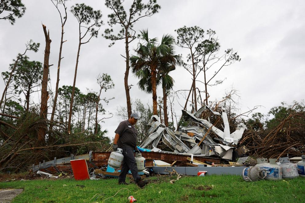 PHOTO:A man collects gas tanks at a gas station destroyed by a tornado after Hurricane Milton made landfall, in Lakewood Park, near Fort Pierce, Fla., Oct. 10, 2024.