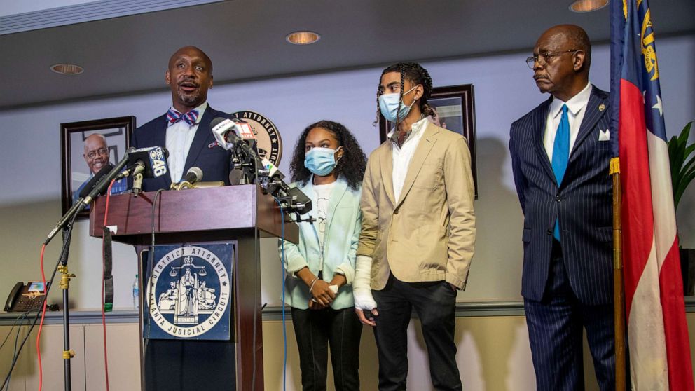 PHOTO: Attorney Mawuli Davis, left, speaks on behalf of Taniyah Pilgrim, center, and Messiah Young, right, during a press conference by the Fulton County District Attorney's Office in Atlanta, June 2, 2020.