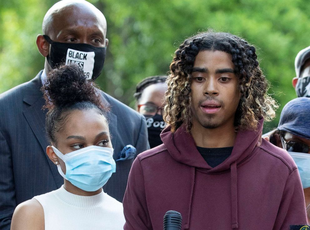 PHOTO: Taniyah Pilgrim holds Messiah Young's bandaged hand as he speaks during a news conference on the campus of Morehouse College, June 1, 2020, in Atlanta.