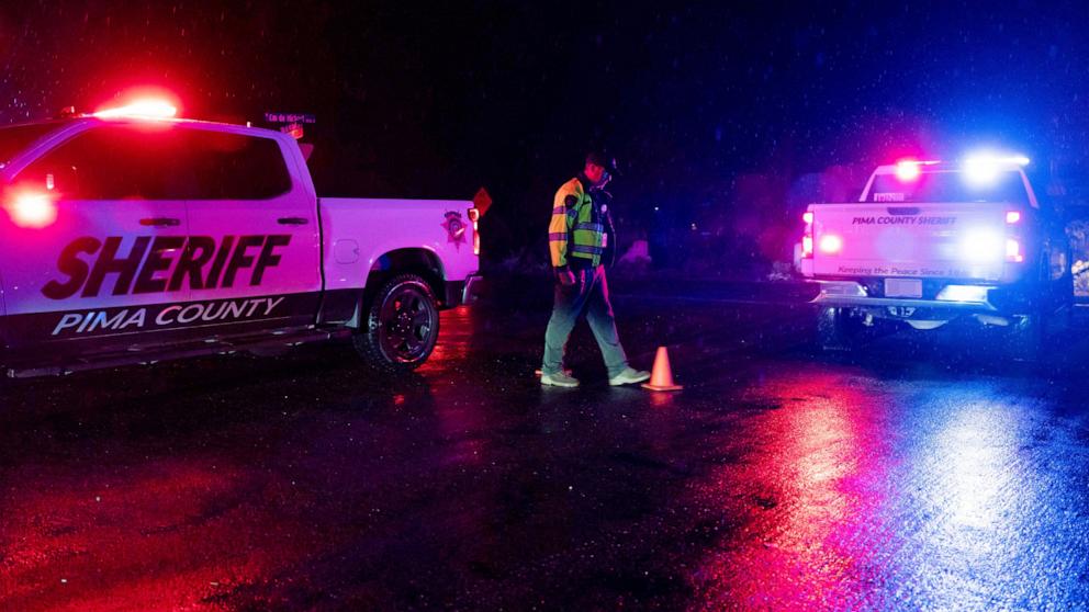 PHOTO: A Pima County Sheriff's deputy maintains a roadblock as a suspected raid regarding the disappearance of Nancy Guthrie takes place in the Catalina Foothills in Tucson, Arizona, Feb. 13, 2026. 