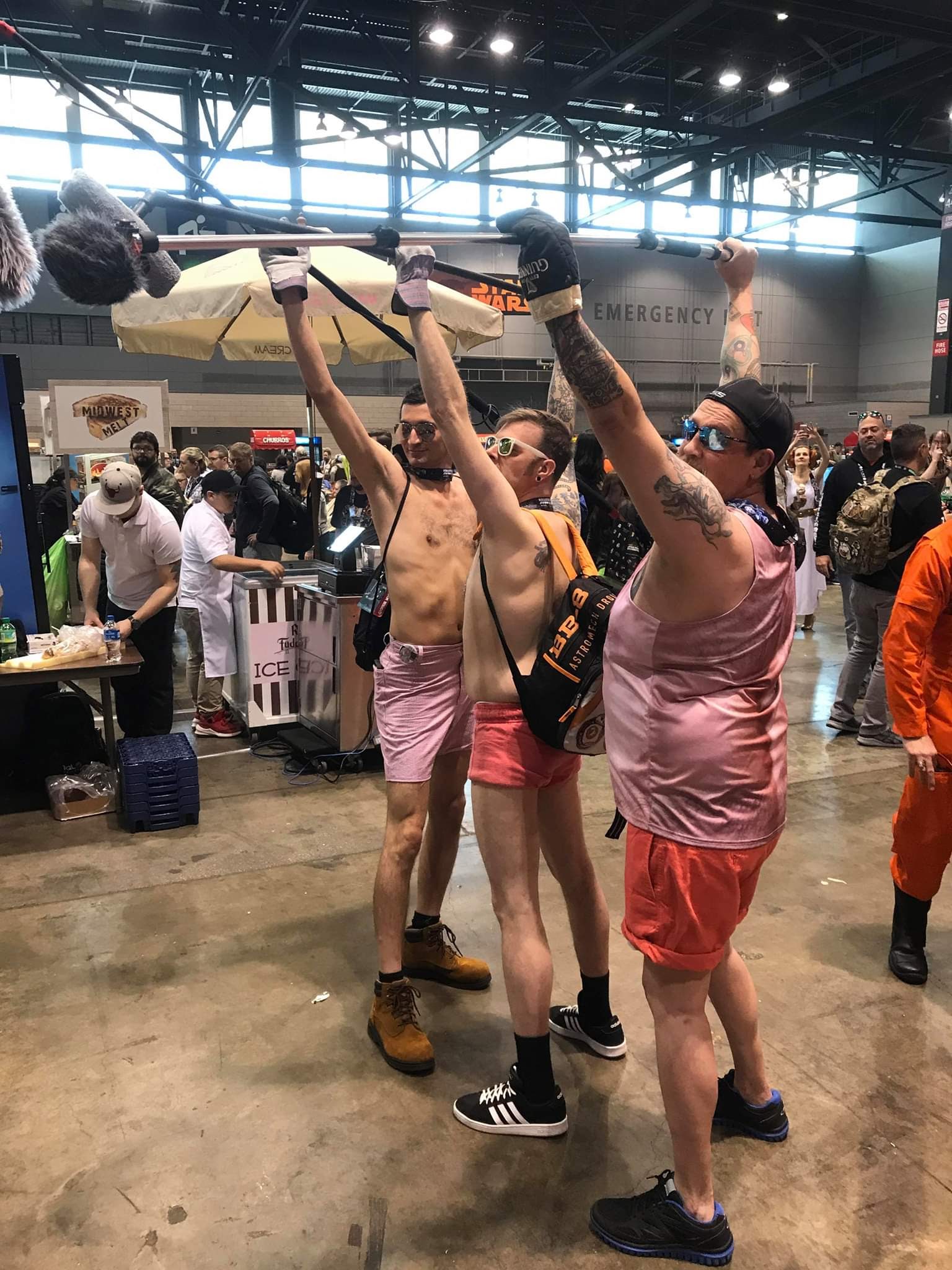 PHOTO: Star Wars super fans Steve Copeland (right) and David Mcintyre (center) pose as "pink shorts boom guy" at the 2019 Star Wars Celebration fan convention in Chicago. 