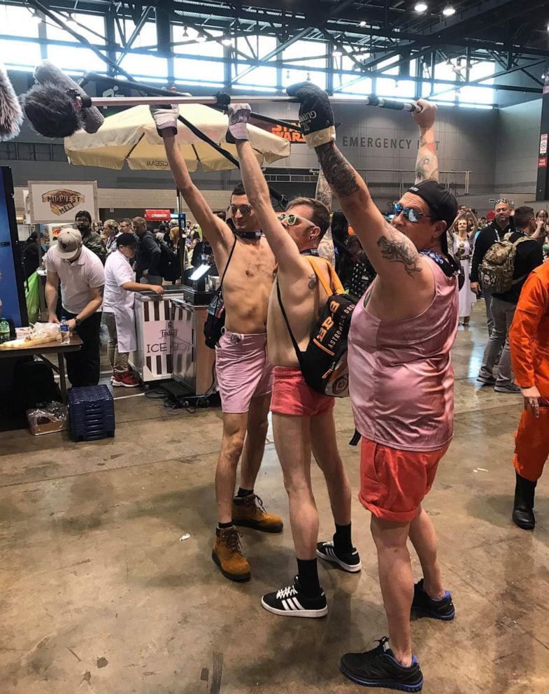 PHOTO: Star Wars super fans Steve Copeland (right) and David Mcintyre (center) pose as "pink shorts boom guy" at the 2019 Star Wars Celebration fan convention in Chicago. 