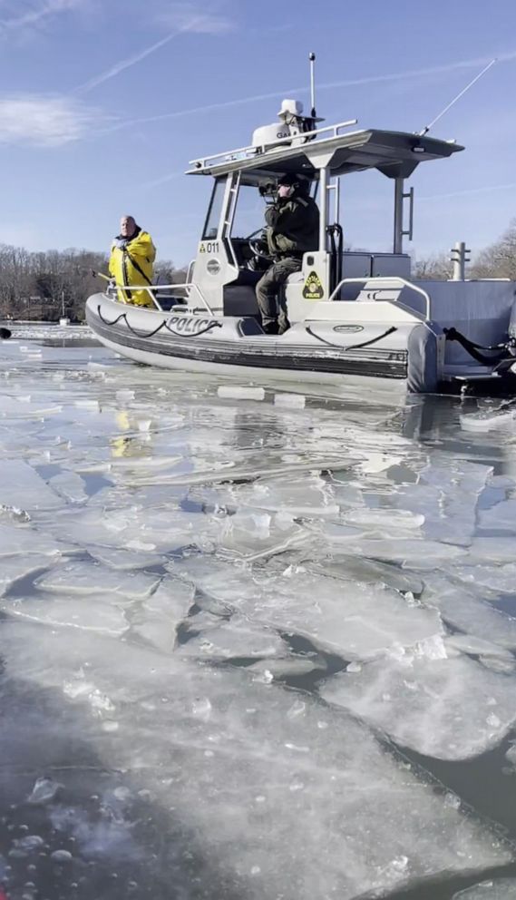 PHOTO: Police assist kayakers after they rescued a pilot after a small plane crashed into frozen creek in Edgewater, Md., Dec. 26, 2022.