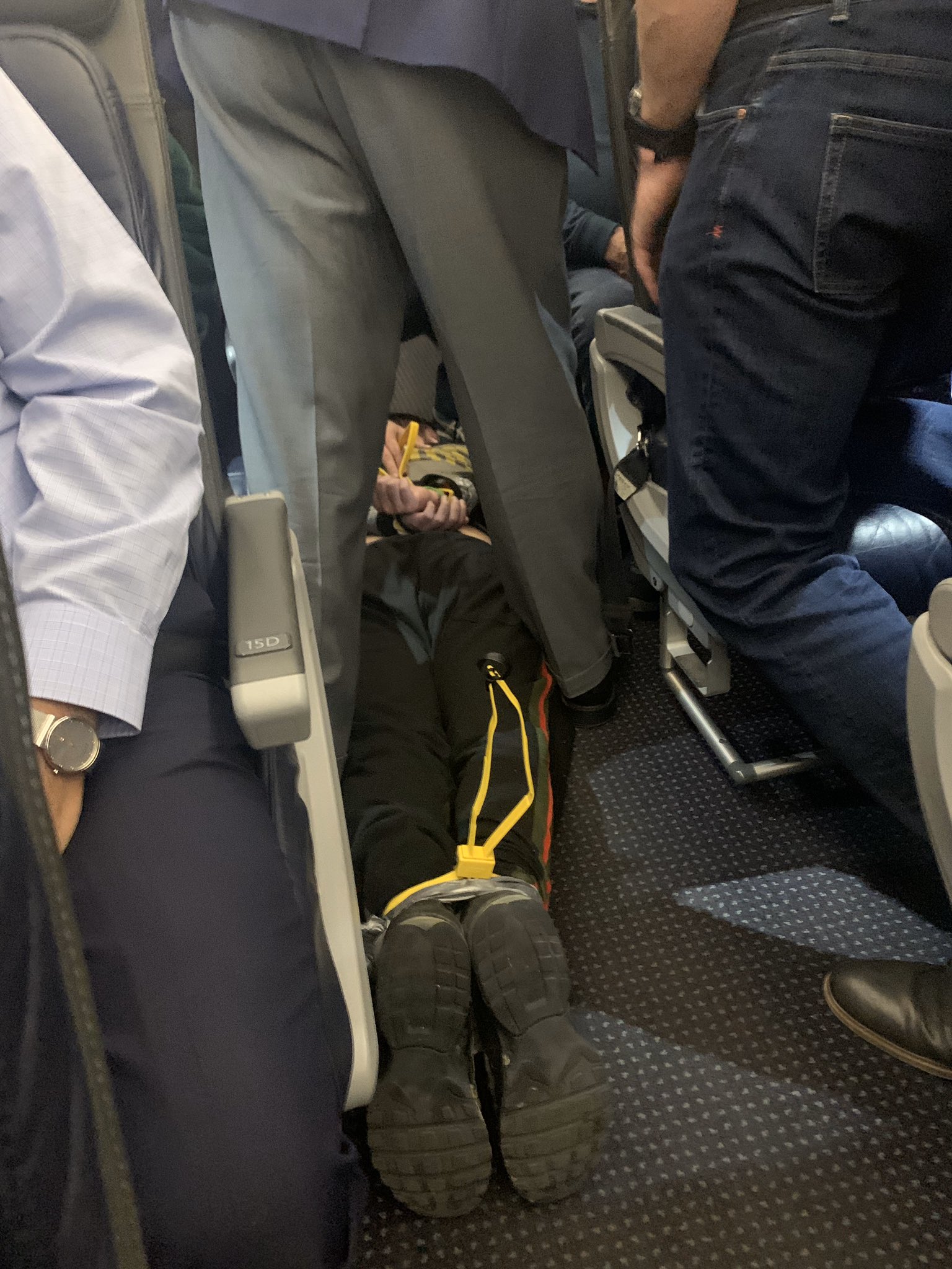 PHOTO: An unidentified passenger had to be removed from a plane after he allegedly tried to open a door midflight. The plane, bound for Dallas-Fort Worth from Chicago, made an emergency landing in St. Louis, March 4, 2020.