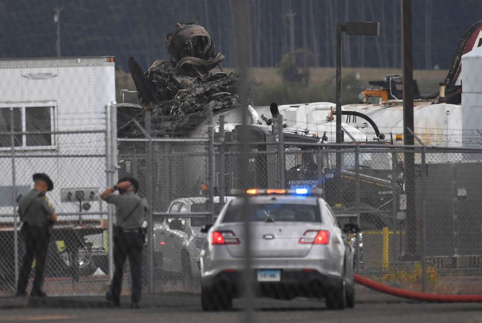 PHOTO: Connecticut State Police stand outside the area of the wreckage of a World War II-era B-17 bomber plane that crashed at Bradley International Airport in Windsor Locks, Conn., Oct. 2, 2019.