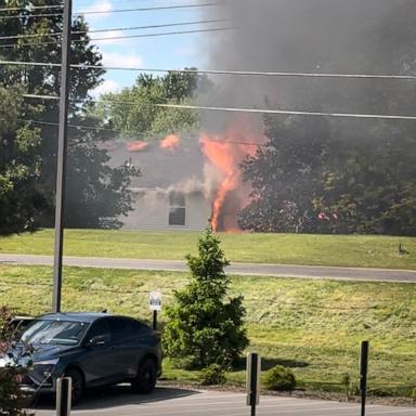 PHOTO: Two people aboard a small plane are dead after the aircraft crashed into a house in Akron, Ohio, causing a fire, authorities said.