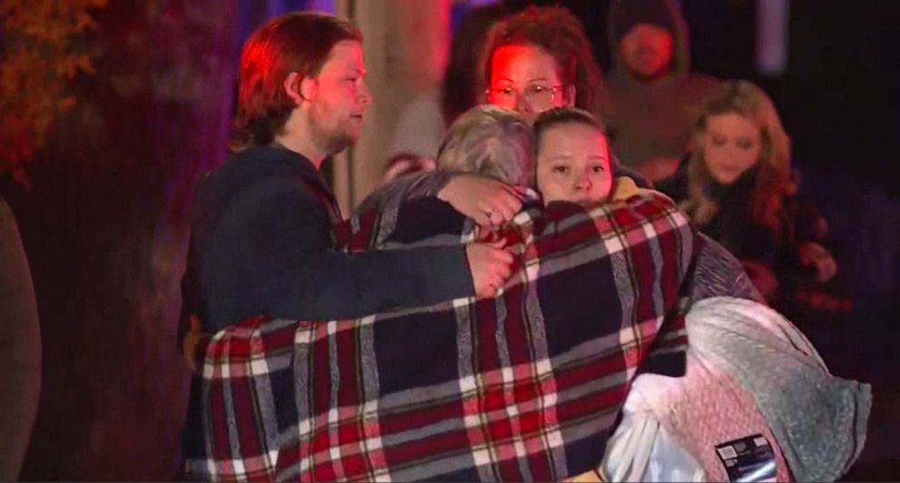 PHOTO: People react at the scene where a small plane crashed into a multifamily building in the evening of Oct. 21, 2022 in Keene, N.H.