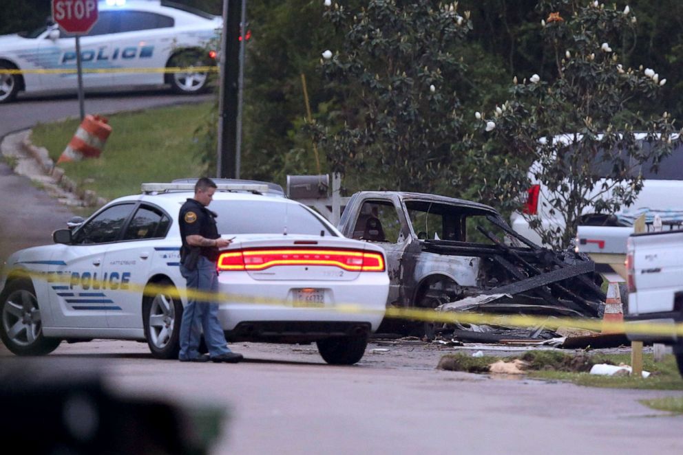 PHOTO: Hattiesburg police surround a burned automobile and a damaged home on May 5, 2021 after a small plane crashed on May 4, in Hattiesburg, Miss.