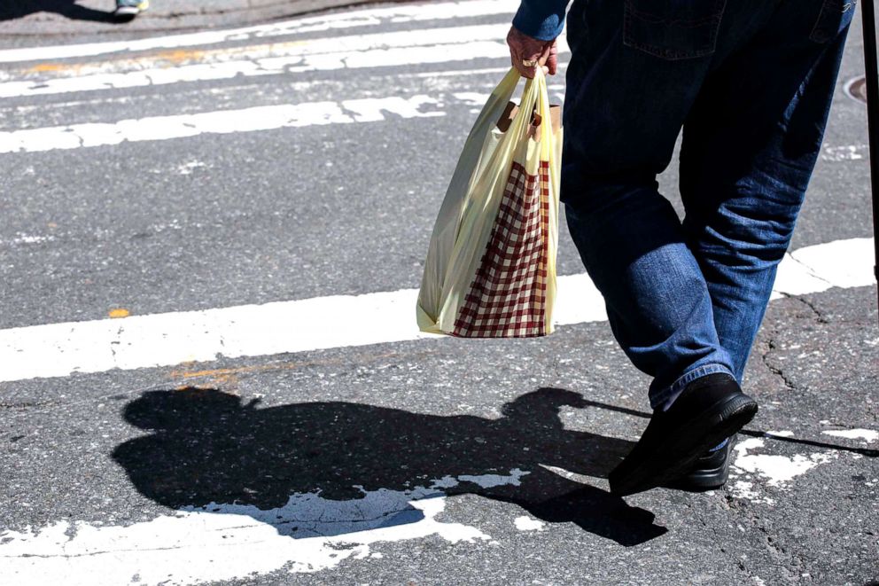 PHOTO:A man carries a plastic shopping bag as he walks Near Central Park in New York City, April 26, 2018.