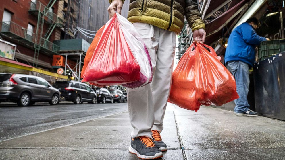 PHOTO: A pedestrian carries plastic shopping bags in New York, March 31, 2019. 